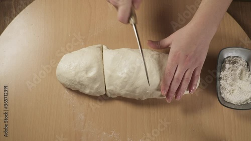 baker kneading and cutting dough