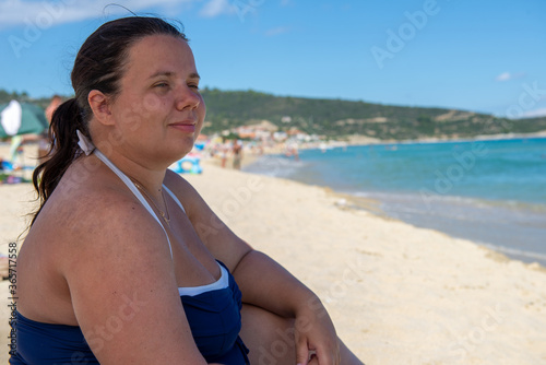 Body positive. Happy plump woman on the beach. 