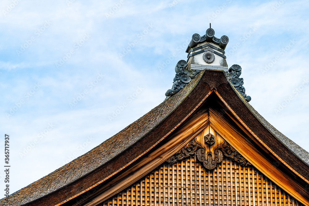 Kyoto, Japan exterior of Imperial Palace in gyoen with closeup of old historic architecture wooden building roof and sky Kyoto, Japan exterior of Imperial Palace in gyoen with closeup of old historic architecture wooden building roof and sky