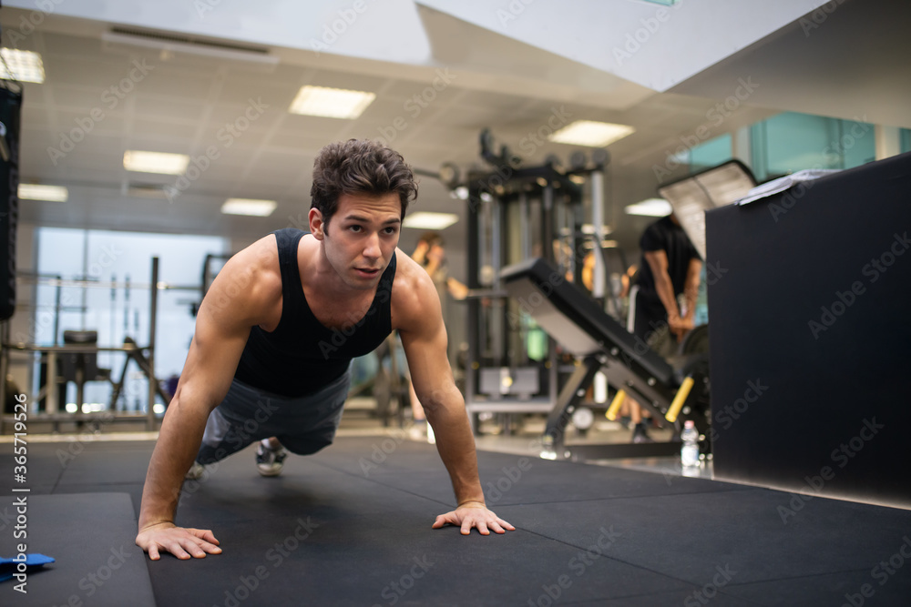 Man doing push ups in a gym Man doing push ups in a gym