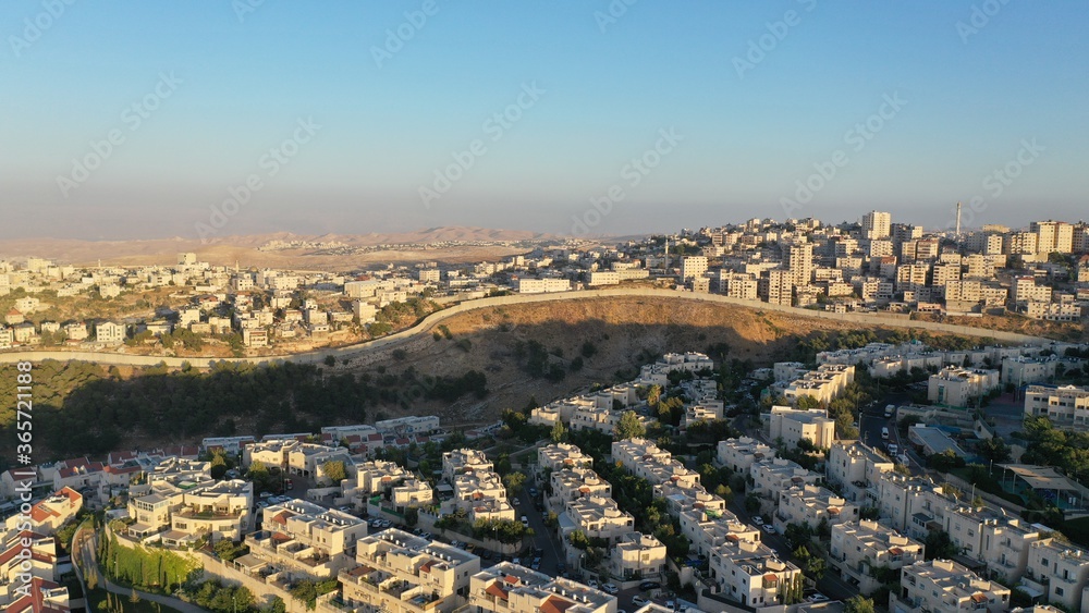 Israel and Palestine divided by Security wall Aerial view
Aerial view of Left side Anata Palestinian town and Israeli neighbourhood Pisgat zeev  
