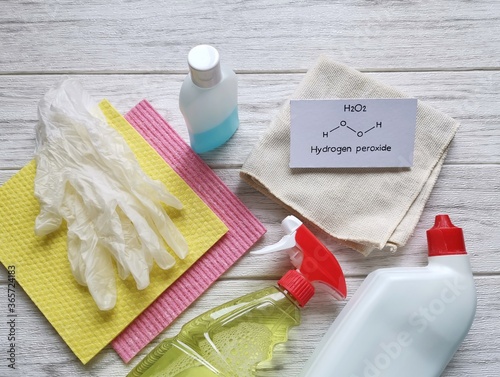 Structural chemical formula of hydrogen peroxide with cleaning products. Hydrogen peroxide is used as a bleaching agent or a disinfectant. Prevention of coronavirus disease (COVID-19), hygiene concept photo