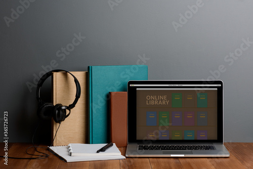 Books, laptop and headphones. Modern education and learning