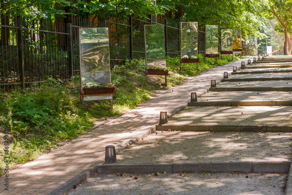 A row of curved mirrors on the street