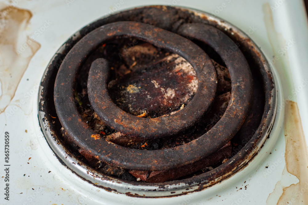 Dirty greasy heating element of an old electric stove