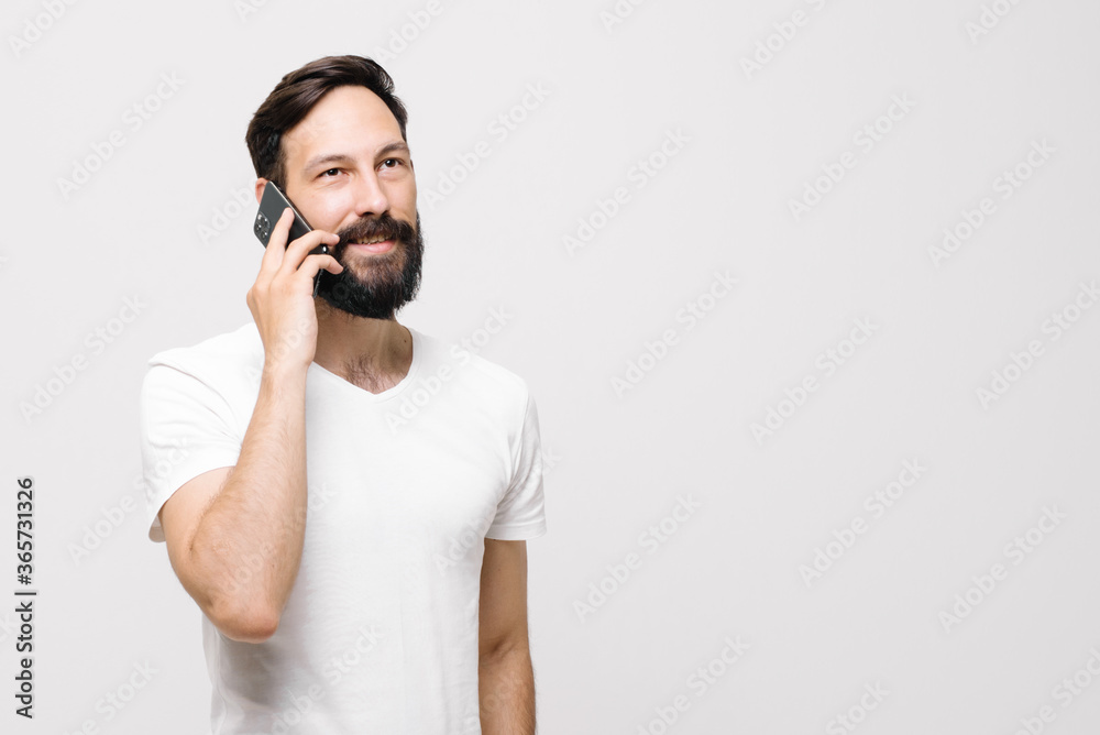 Happy young man is using a mobile phone. Happy young man is using a mobile phone.