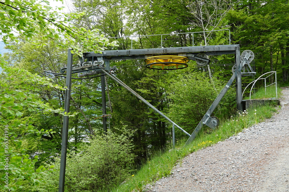 A small ski lift technology installed on a hill. In summer it is out of use and waits for the next season. Region Engelberg canton Obwalden in Switzerland.