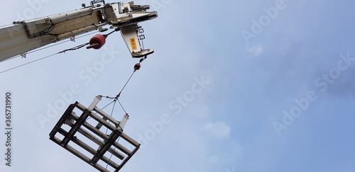 Crane lifts a metal frame 