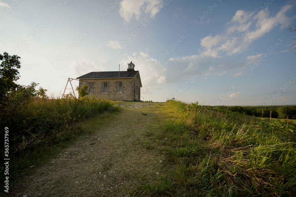 old abandoned one-room school house on the open prairie of Kansas