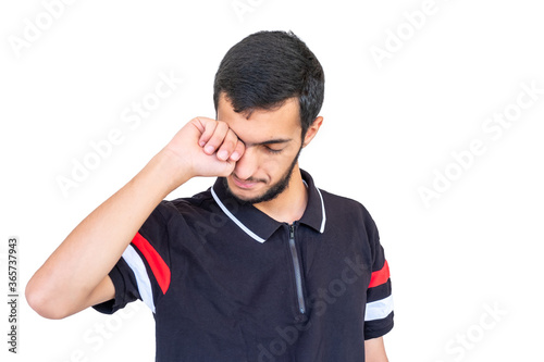 Arabic guy feeling sleepy and tired and rubbing his eyes © Diya