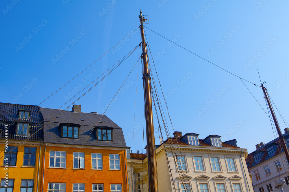 Houses and boats of Nyhavn . Famous water canal and entertainment district in Copenhagen , Denmark.
