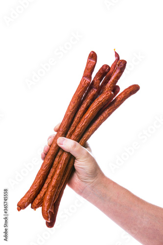 Man Holding Kabanos or Cabanossi Thin Dry Smoked Polish Sausage Isolated on White background. Selective focus. photo