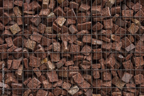 The texture of the gabion fence is made of natural stone and metal mesh photo