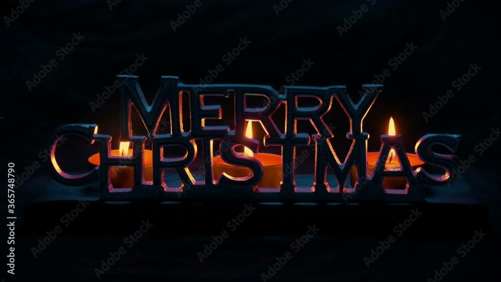 Merry Christmas Lit Up With Candles In The Dark