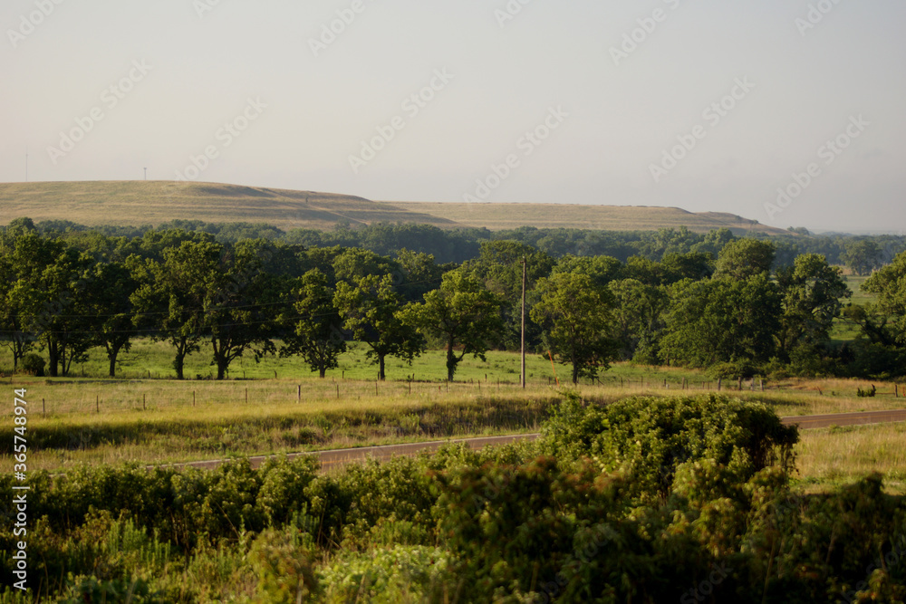 Kansas landscape with trees and hills and a highway