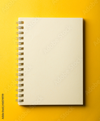 Blank Note Book On Yellow Background
