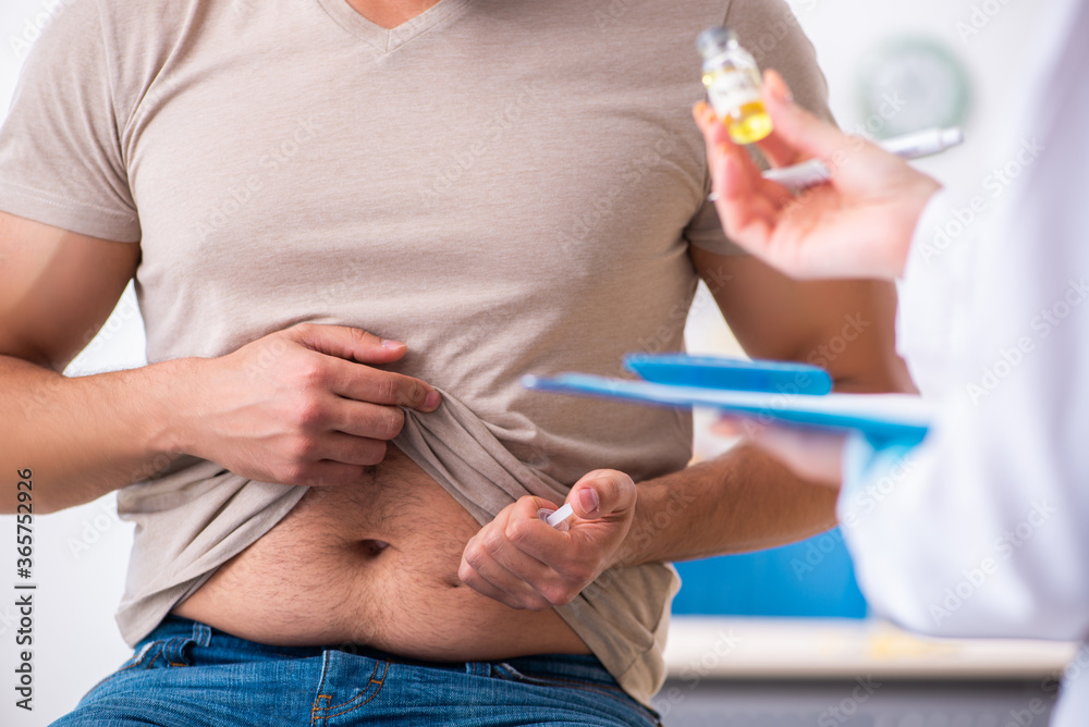 Male diabetic patient visiting young female doctor Male diabetic patient visiting young female doctor