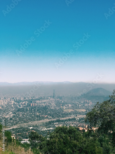 Amazing view of Santiago with pollution and blue sky from the top of the Manquehuito hill (Chile)