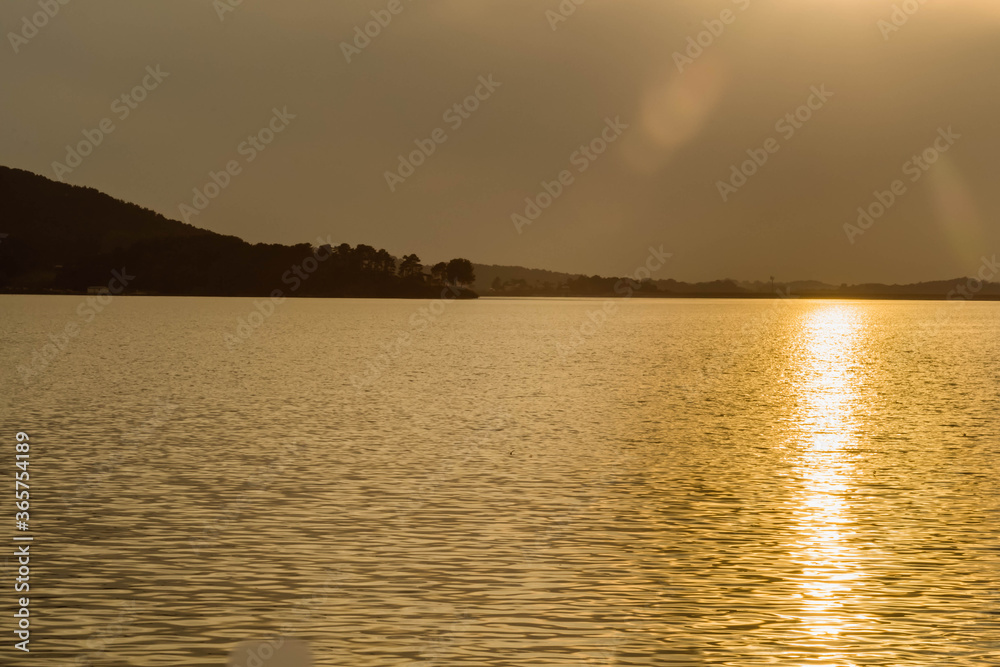 Peaceful scene of lake at sunset