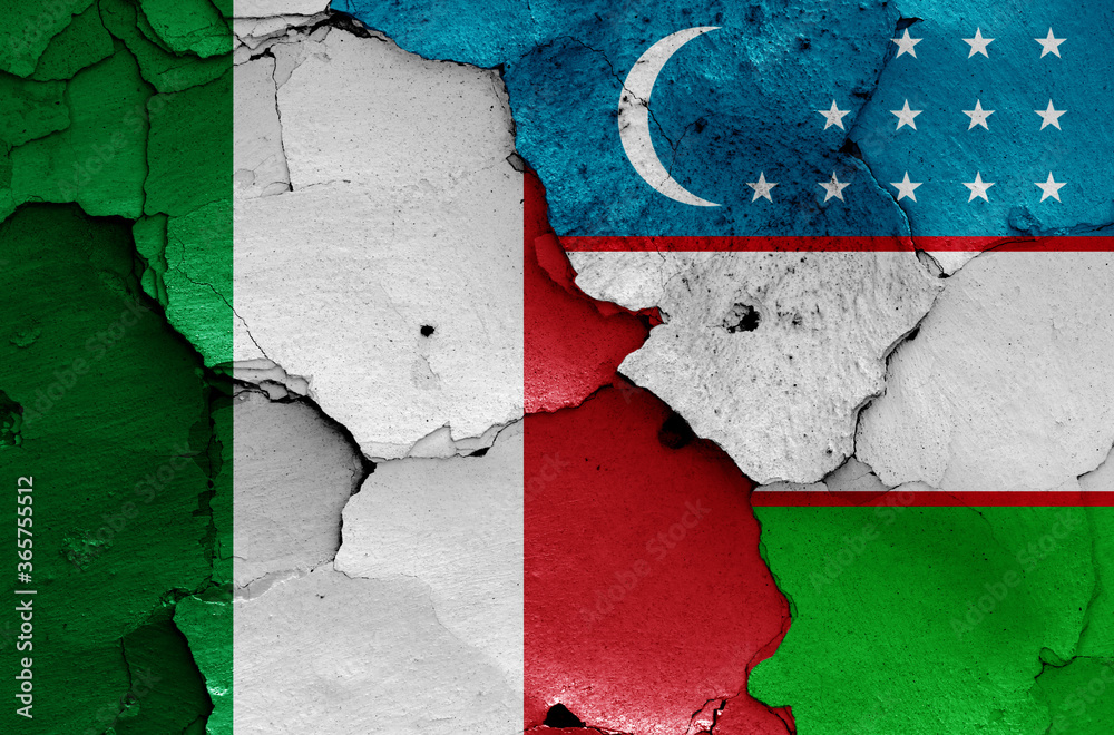 flags of Italy and Uzbekistan painted on cracked wall