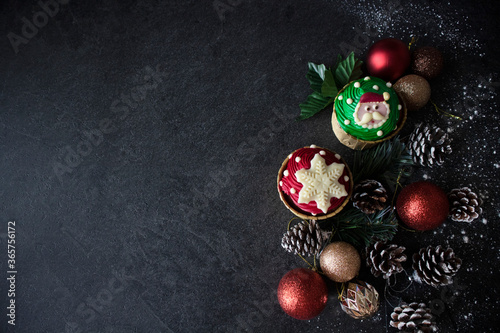 Cute Christmas Cupcakes on Black Background. Santa Cupcakes With Copy Space. Chocolate Cupcakes Dark Food Photography.