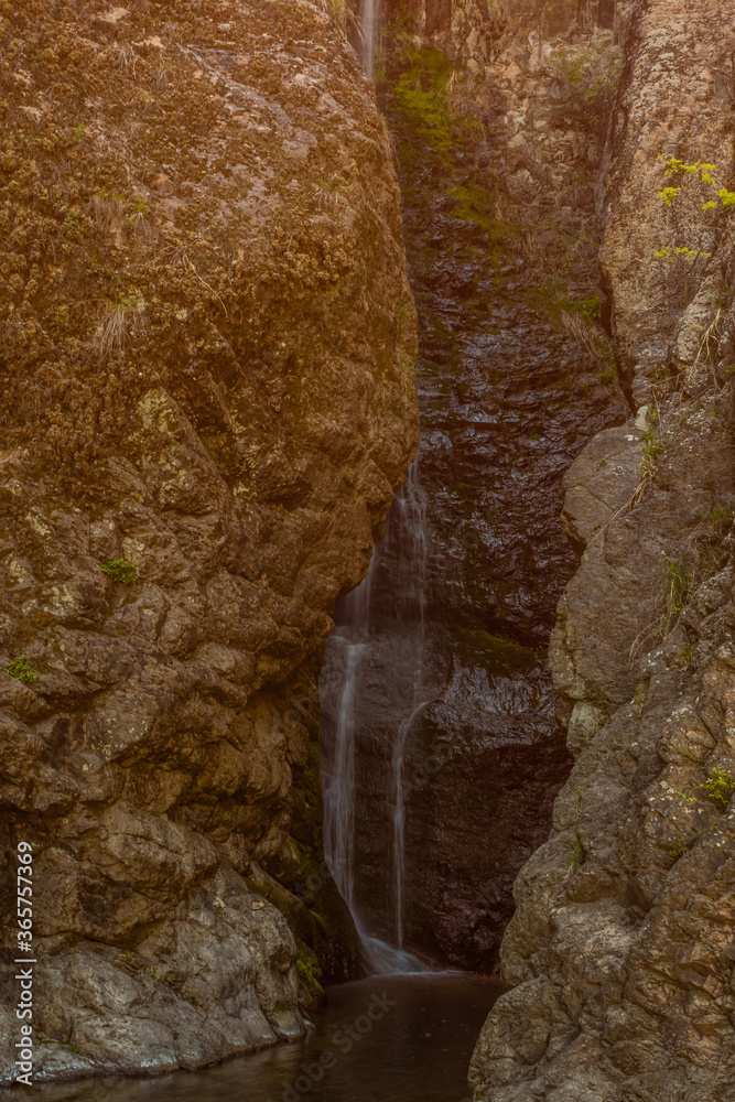 Waterfall cascading down granite wall