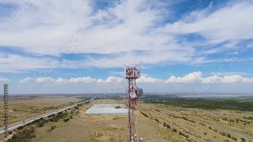 Closeup aerial view around a telecommunication tower.
The antenna fired at a telecommunications tower with sector antennas of a cellular operator and radio relay equipment outside the city. Telecom photo