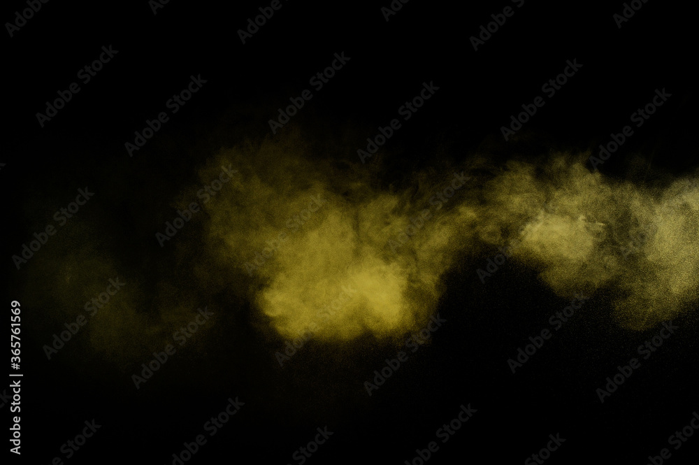 Yellow powder explosion on black background. Colored powder cloud. Colorful dust explode. Paint  Holi.