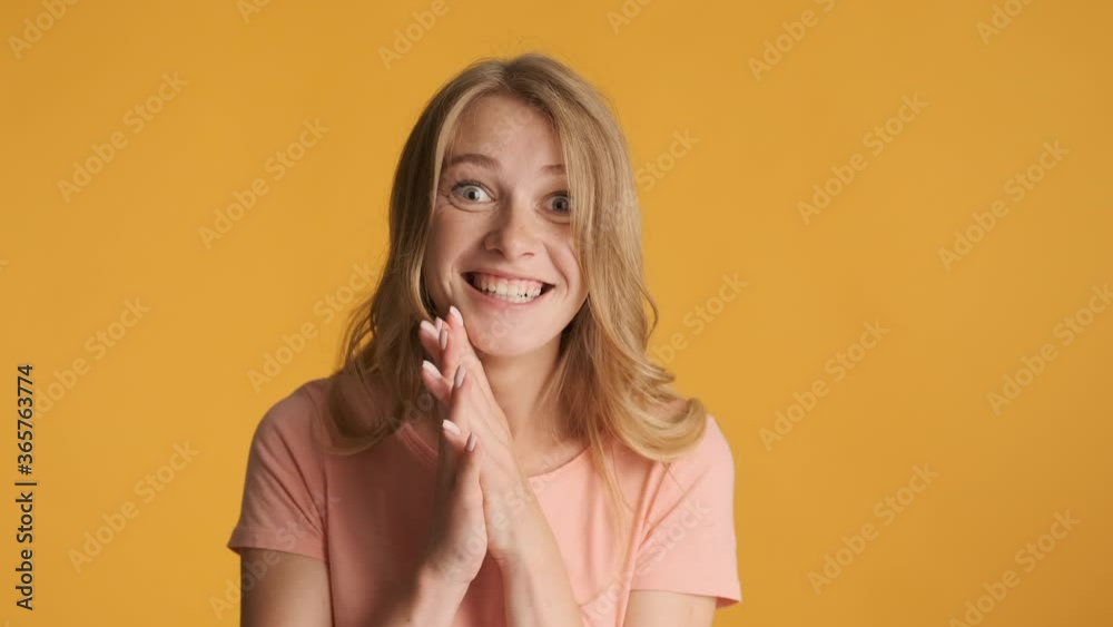 Beautiful cheerful excited girl rejoicing on camera over colorful background. Victory expression Beautiful cheerful excited girl rejoicing on camera over colorful background. Victory expression