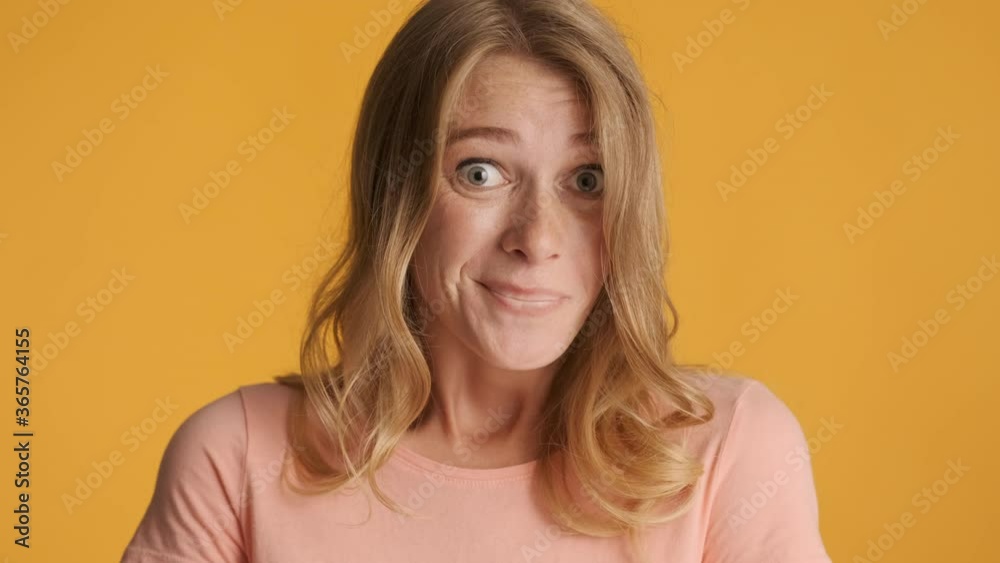 Attractive blond girl guilty looking in camera over colorful background. Oops expression. Sorry Attractive blond girl guilty looking in camera over colorful background. Oops expression. Sorry