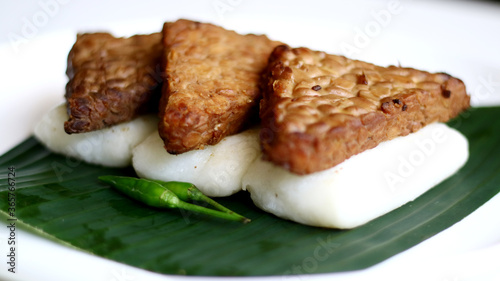 Jadah bacem on banan leaf. Jadah combined with tempe bacem. Indonesian food from yogyakarta. photo