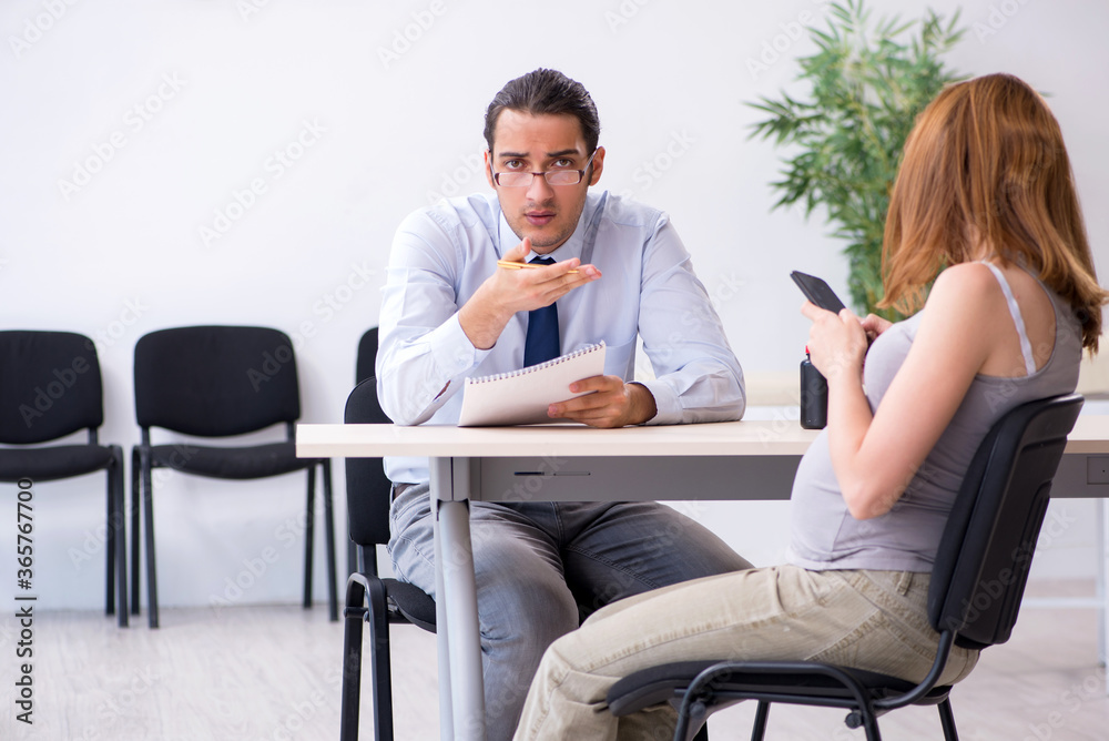 Pregnant woman visiting male psychologist doctor Pregnant woman visiting male psychologist doctor