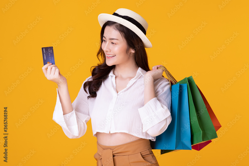 Asian woman holding creadit card and shoppingbag with mid year sale. Asian woman holding creadit card and shoppingbag with mid year sale.