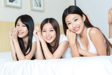 Pretty young girls   smiling together in bedroom