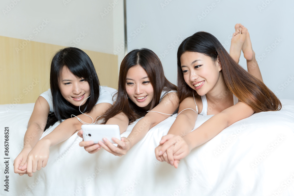 Pretty young girls taking selfie with smartphone indoors Pretty young girls taking selfie with smartphone indoors