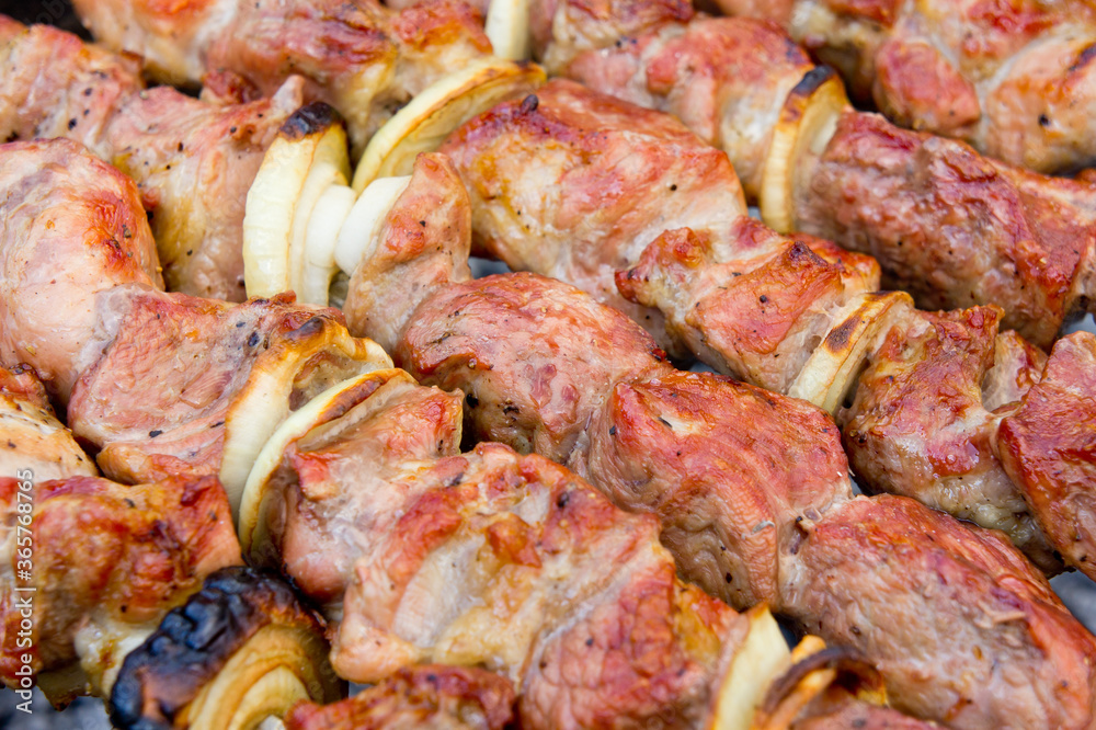 Skewers of pork meat strung on skewers, cooked on the grill.