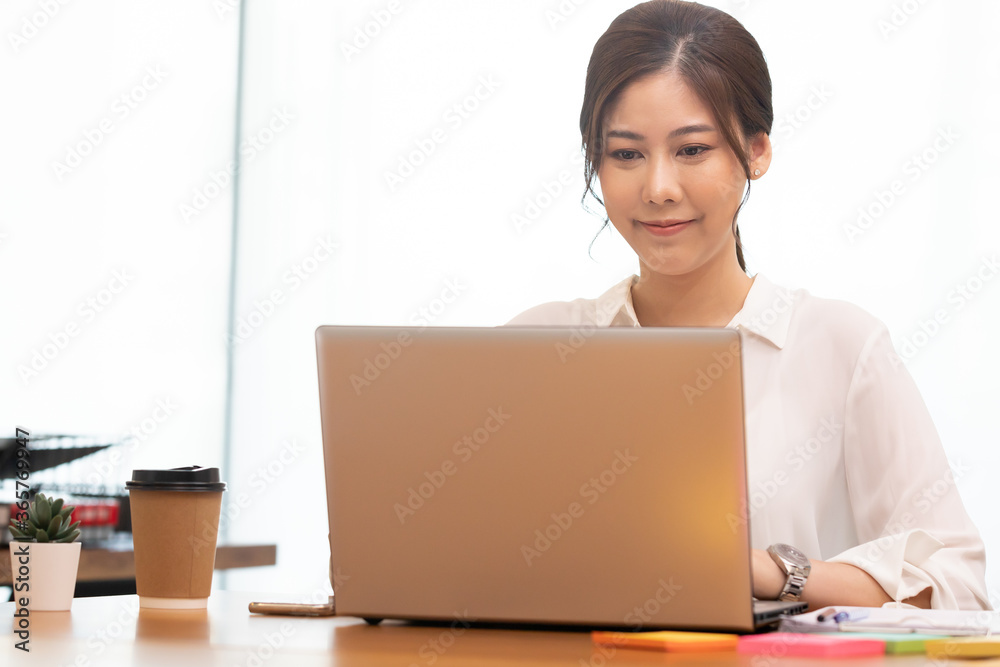 Business asian woman happy working job on laptop in office. Business asian woman happy working job on laptop in office.