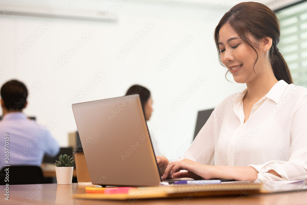 Business asian woman happy working job on laptop in office. Business asian woman happy working job on laptop in office.