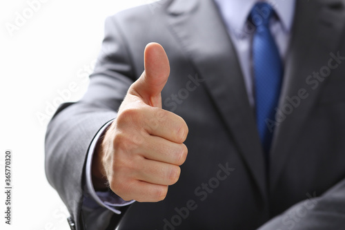 Male hand showing OK or confirm sign with thumb up during conference closeup. High level and quality product, serious offer, mediation solution, happy client, creative adviser participation concept