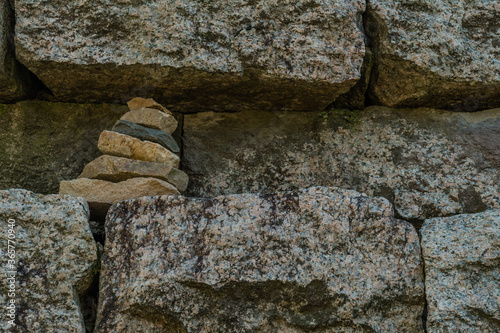 Pyramid of rocks in fortress wall photo