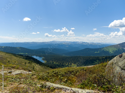The view from the top of the mountain. Light Lake in the Ergaki Nature Park. Panorama of the distant Siberian mountains