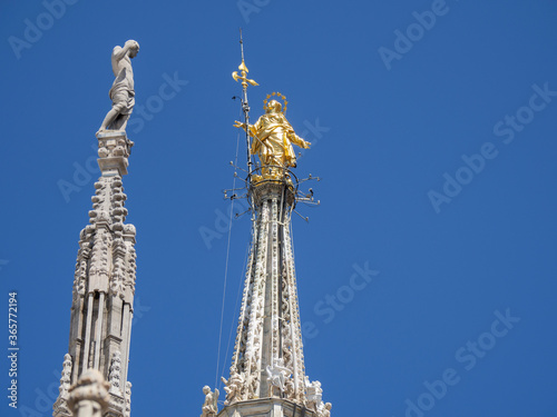 Milano, Italy. The famous Madonnina in gilded copper and placed on the main spire of the cathedral of Milan. A statue of the Virgin Mary. One of the main symbol of the city of Milan