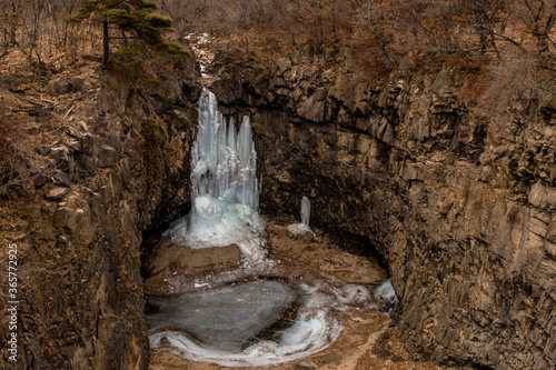 Frozen waterfall in deep crater l photo