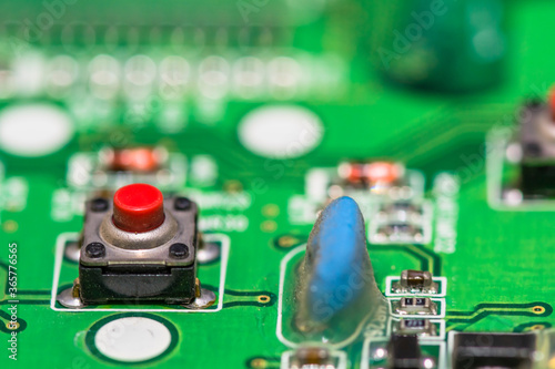 Obraz na płótnie Red button on green circuit board