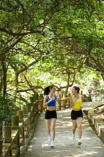 Young Asian woman doing exercise outdoors