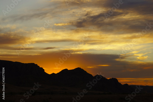 Beautiful clouds on a background of mountains during sunset.