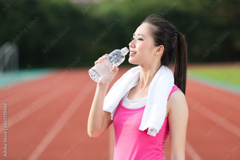 Young Asian woman doing exercise outdoors