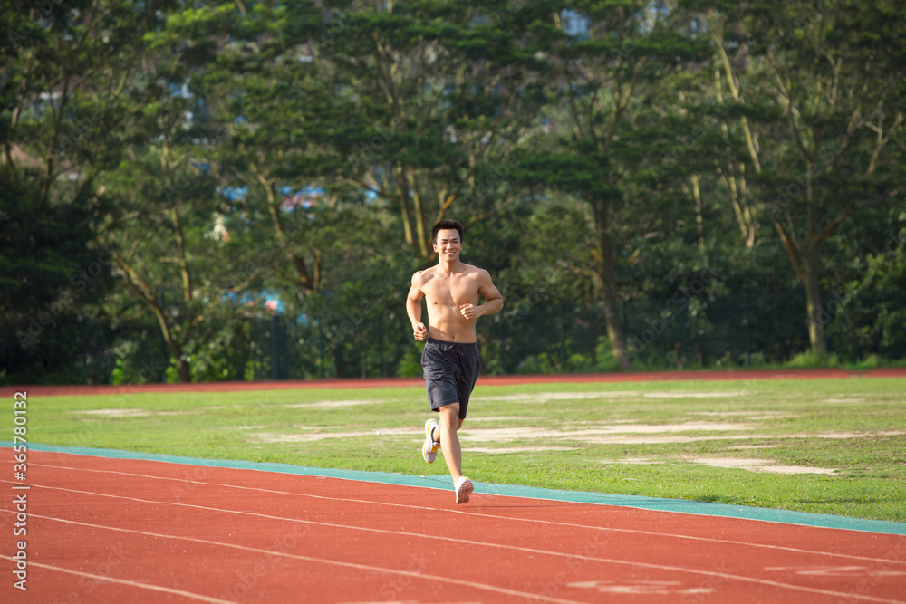 Young Asian man doing exercise outdoors