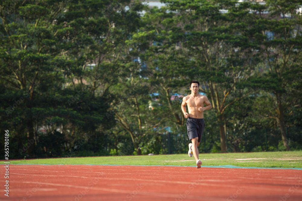 Young Asian man doing exercise outdoors