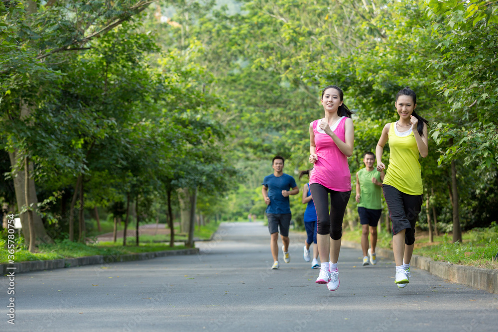 Group of friends running together outdoors